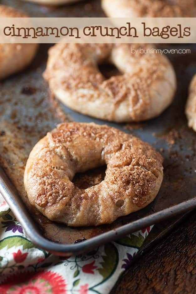 A close up of cinnamon bagels on a baking sheet.