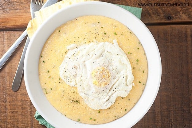 Overhead view of fried eggs on top of a bowl of grits.