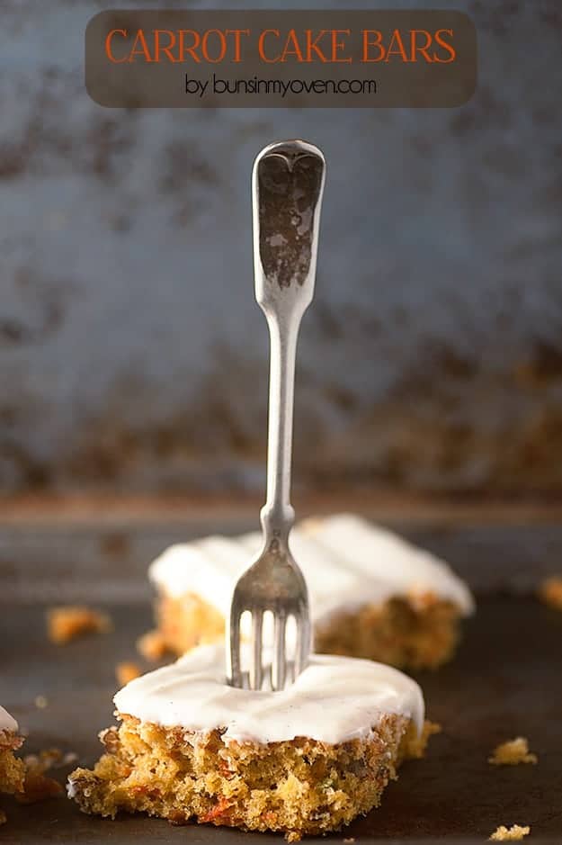 A decorative fork stabbed into a piece of carrot cake.