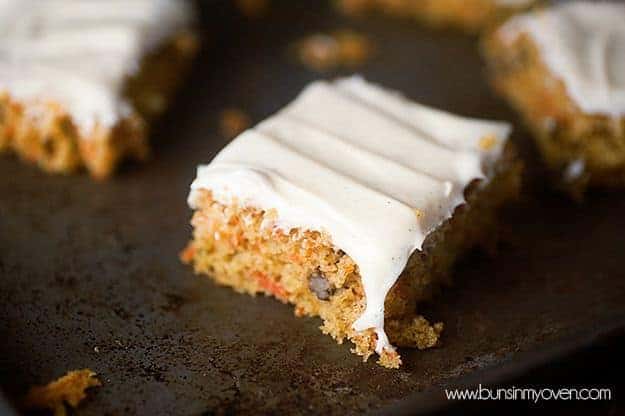 A square slice of carrot cake on a baking sheet.