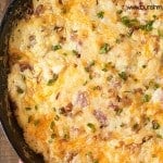 Overhead view of ham and cheese dip in a cast-iron skillet.