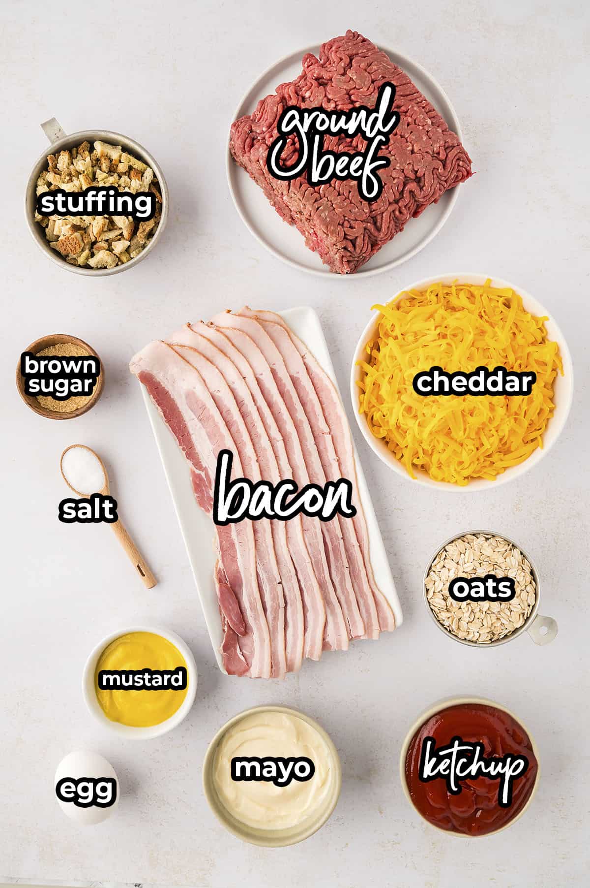 Ingredients for cheeseburger meatloaf laid out in individual dishes.