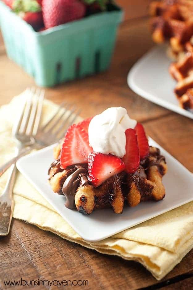 Loaded with chunks of sugar, these liege waffles are SO not your typical breakfast waffle! Topped with Nutella and strawberries!