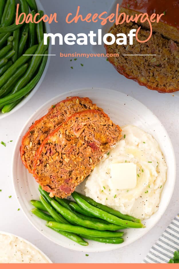 Slices of meatloaf on white plate with mashed potatoes and green beans.