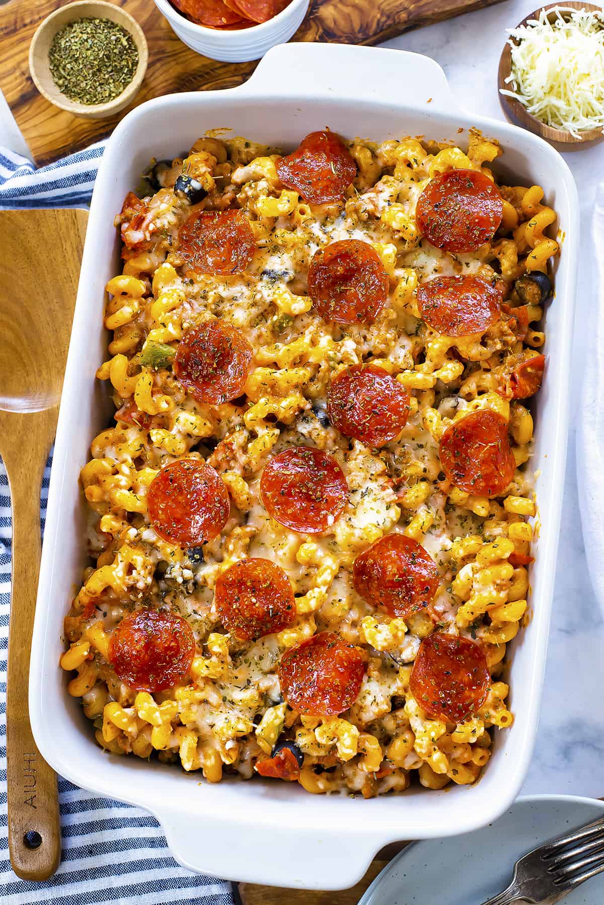 Overhead view of pizza pasta in white baking dish.