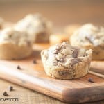 A caramel cookie cup on a wooden cutting board.