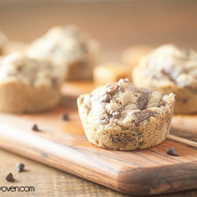 A caramel cookie cup on a wooden cutting board.