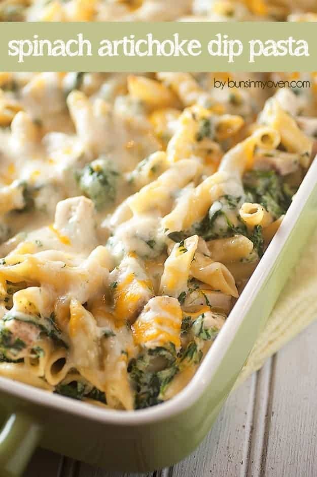 Overhead view of cheesy chicken artichoke dip pasta in a baking pan.