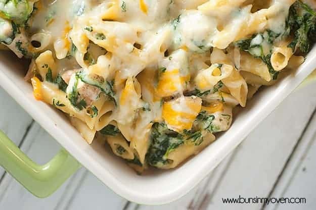 Spinach artichoke dip pasta in a baking dish.