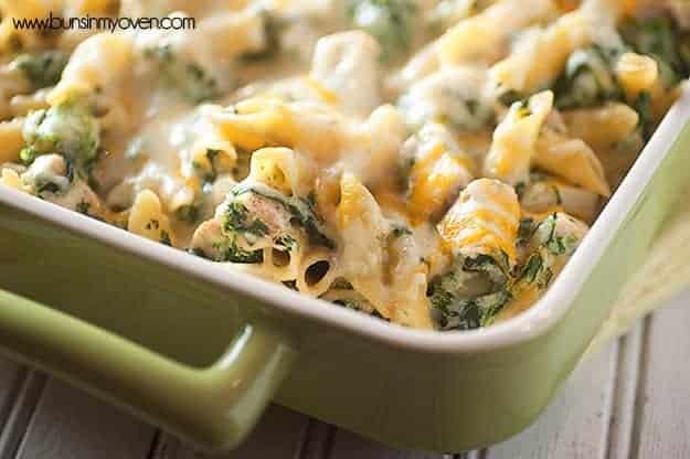 A baking dish with cheesy spinach pasta.