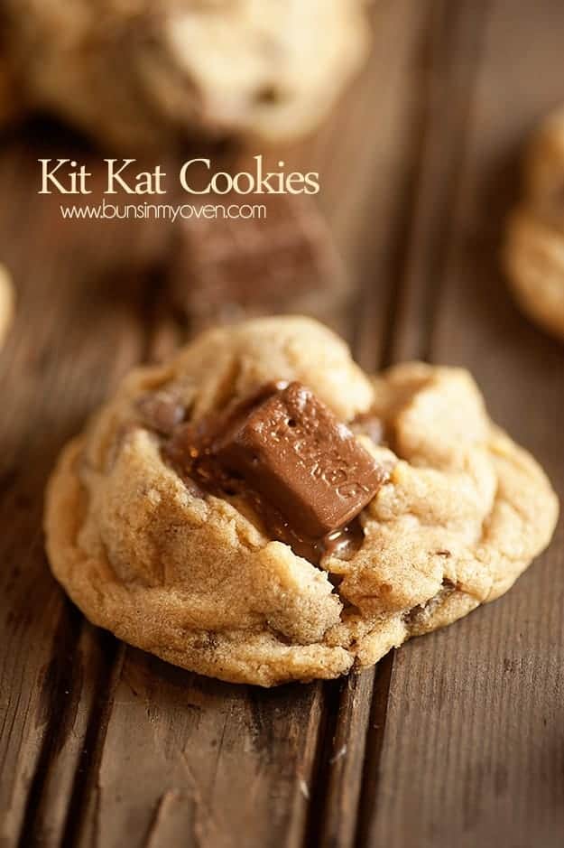 A close up of kit kat bar chunks in a cookie.