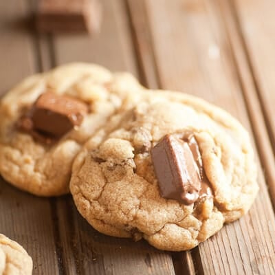 A close up of a couple of cookies with kit kat bars in it.