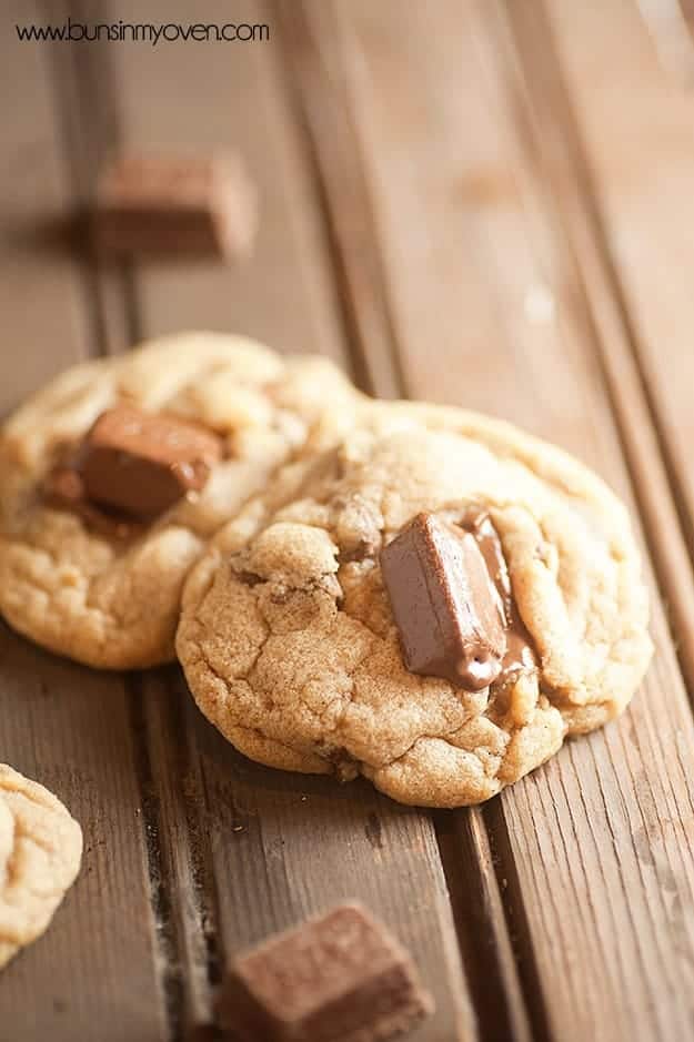 A close up of a couple of cookies with kit kat bars in it.