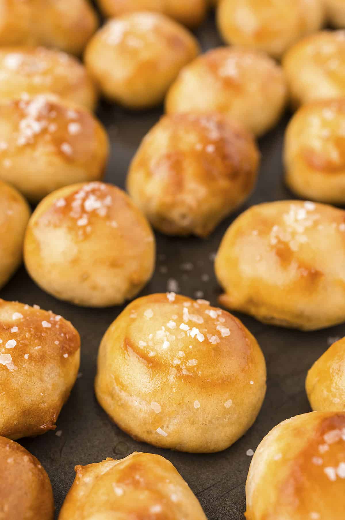 Close up of pretzel bites on baking sheet.
