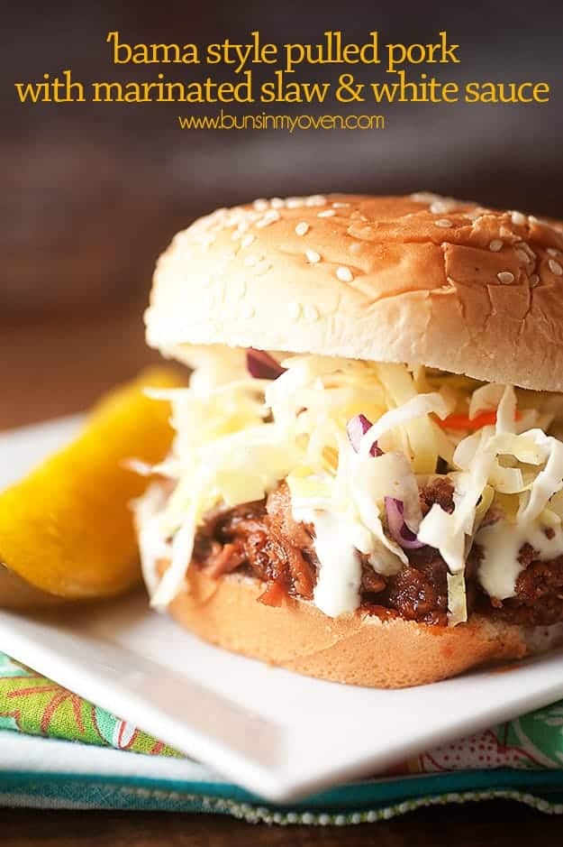 A pulled pork and coleslaw sandwich on a sesame seed bun.