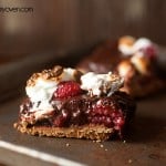 A close up of a raspberry smores bar on a thin baking sheet.