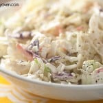 A close up of coleslaw in a white bowl.