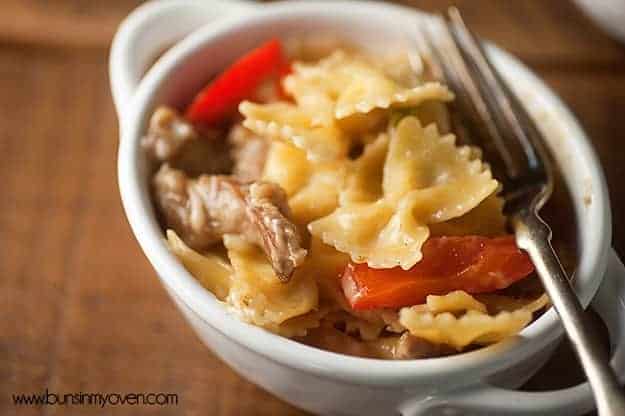 A white soup cup full of Philly cheesesteak pasta.