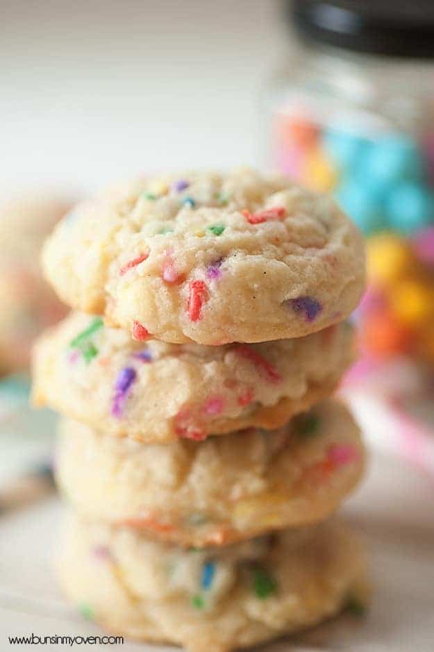 A close up of a stack of sugar cookies with confettti sprinkles in them.