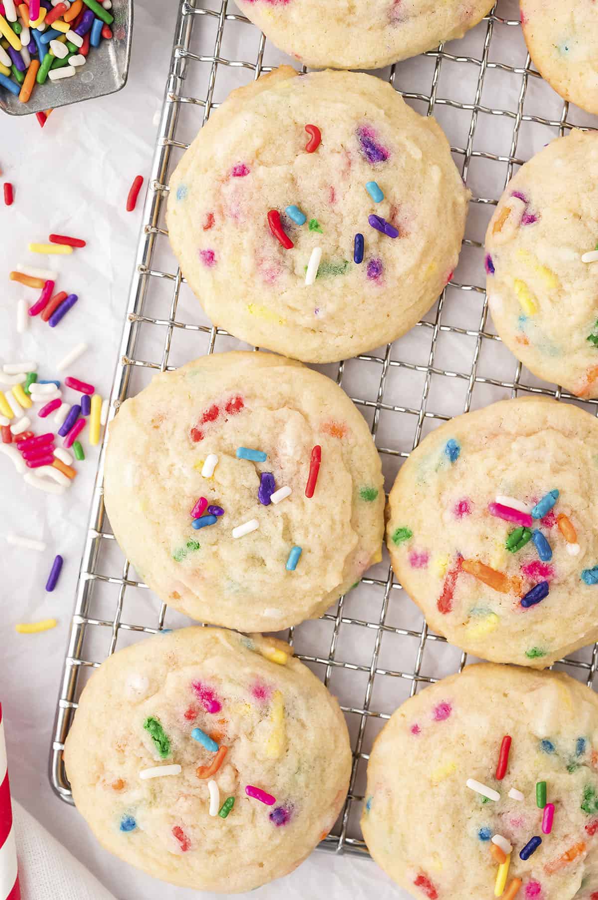 Drop sugar cookies with sprinkles on cooling rack.