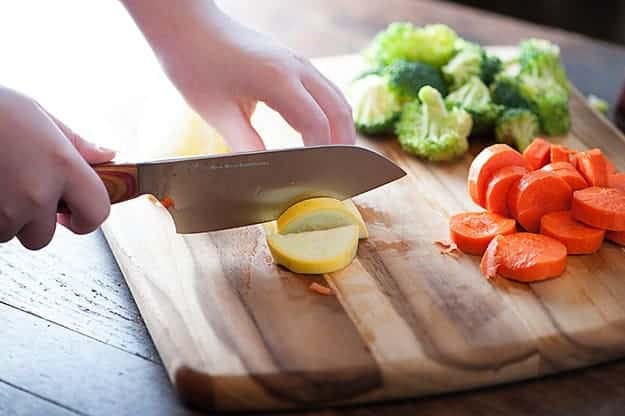 chopping vegetables for cheesy casserole