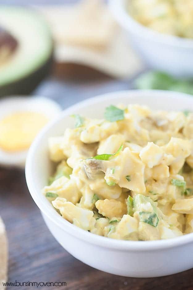 Egg salad chip dip in a small white bowl.