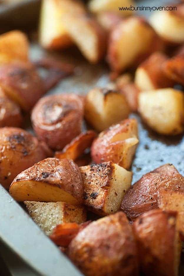 Oven Roasted Potatoes tossed in bacon grease, with garlic, parmesan, and crispy bacon pieces