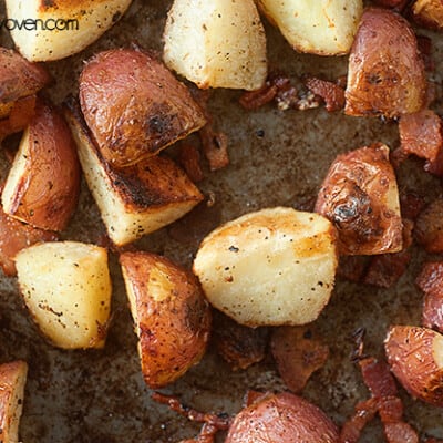 Seasoned roasted potatoes on a baking sheet.
