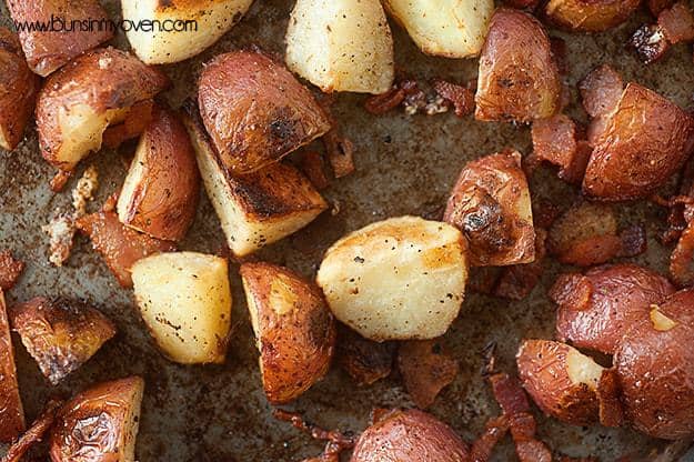 Seasoned roasted potatoes on a baking sheet.