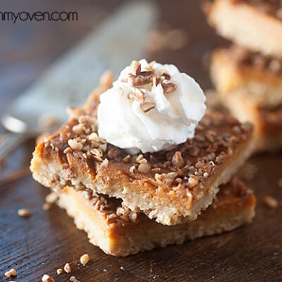 Pecan oatmeal bars stacked on a table.