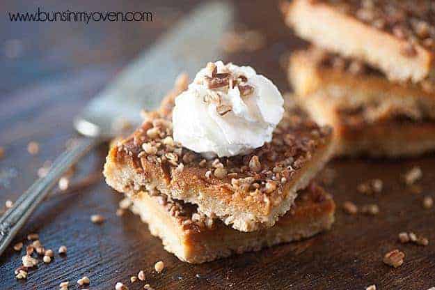 Pecan oatmeal bars stacked on a table.