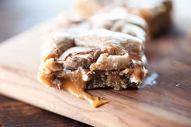 A close up of a caramel blondie on a cutting board.