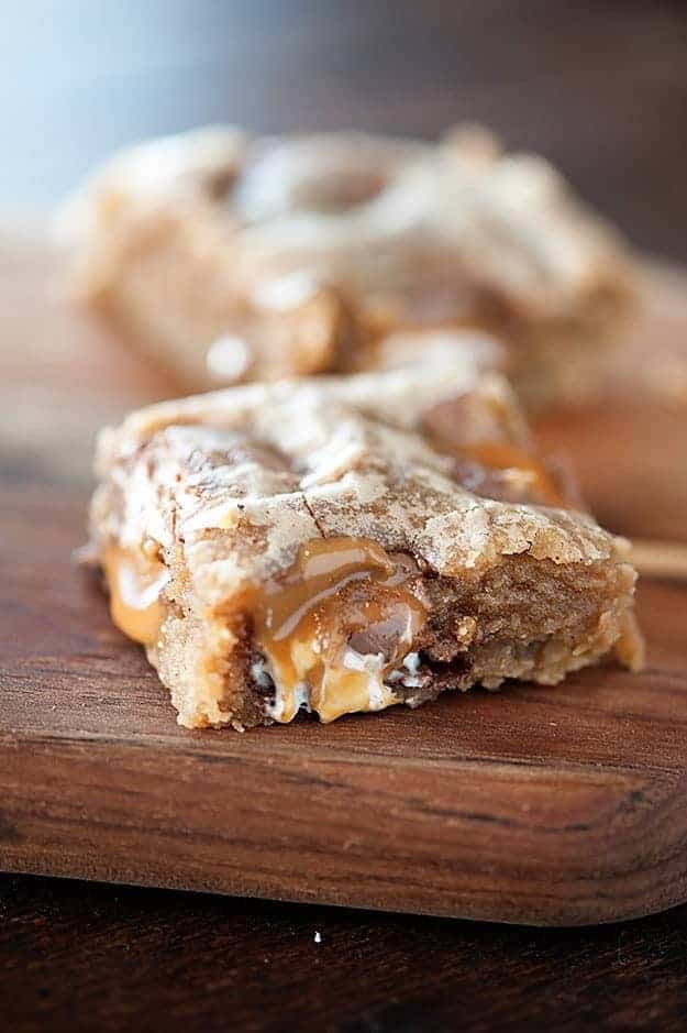 A close up of an apple blondie on a wooden cutting board.