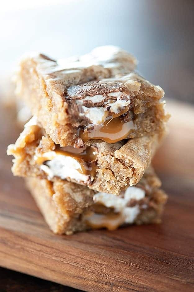 A close up of three stacked caramel apple blondies.