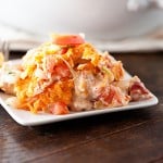 Dorito and chicken casserole piled up on a square plate.