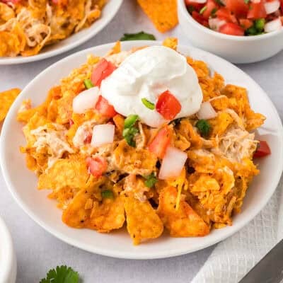 White plate topped with chicken doritos bake.