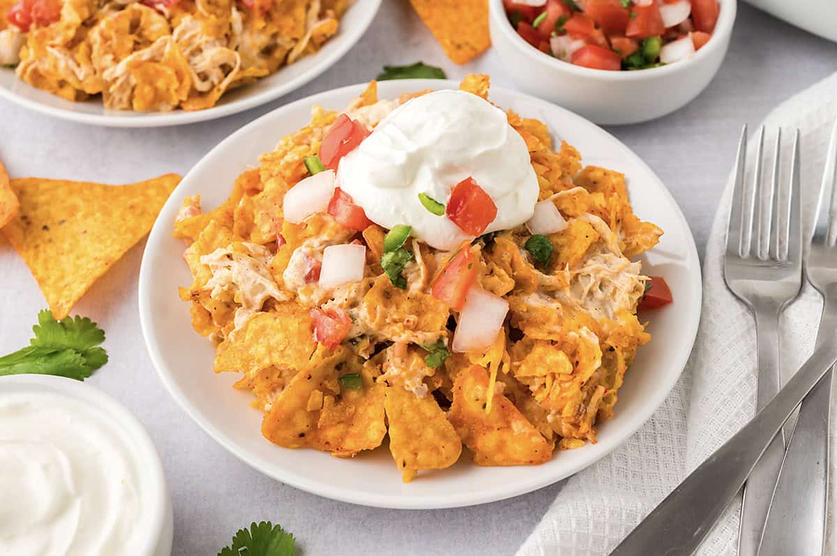 White plate topped with chicken doritos bake.