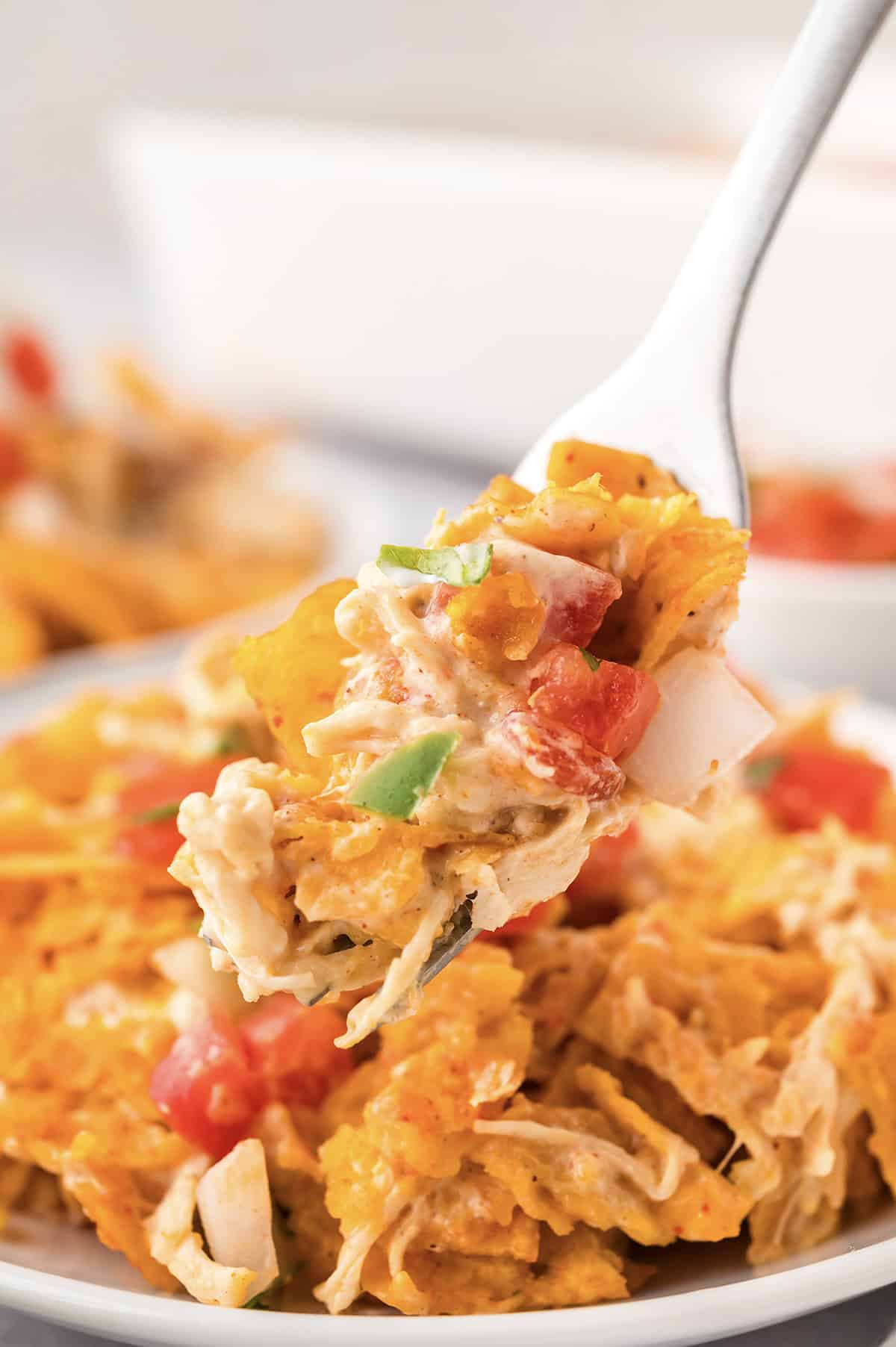 Fork full of Dorito chicken casserole.