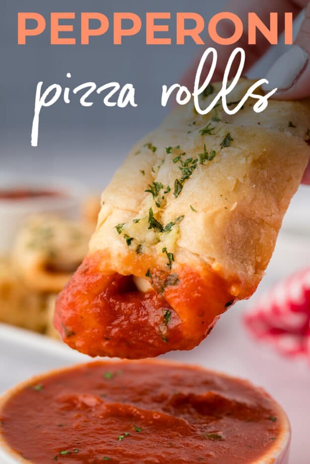 Pizza roll being dipped in pizza sauce.