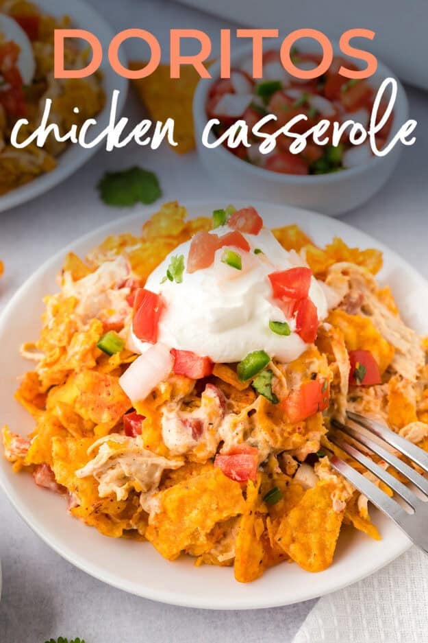 Small white plate topped with a pile of chicken casserole with doritos.
