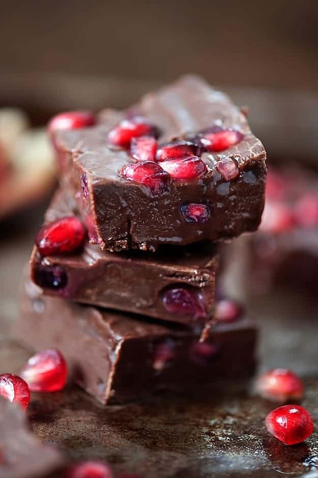 Pomegranate chocolate fudge squares stacked up.