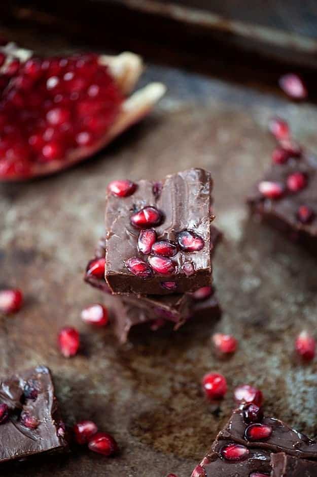 Chocolate pomegranate fudge squares on a table.