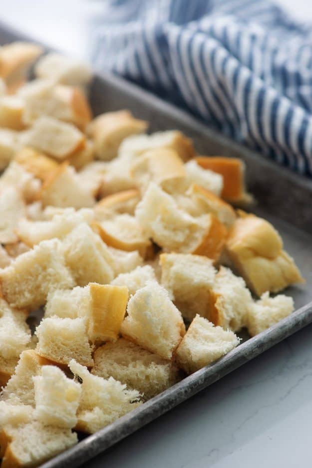 bread cubes on baking sheet.