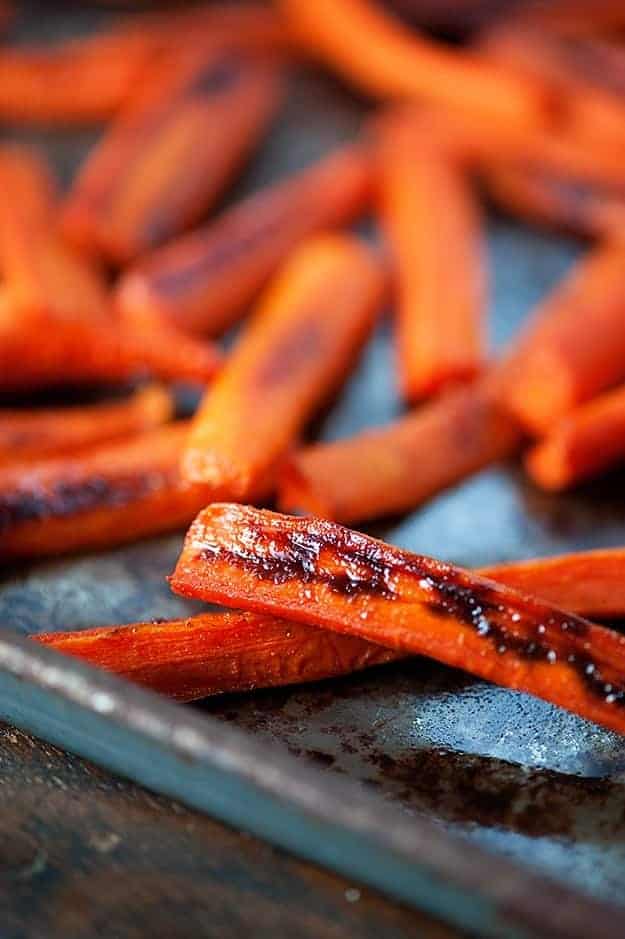 Maple glazed carrot slices on a baking sheet.