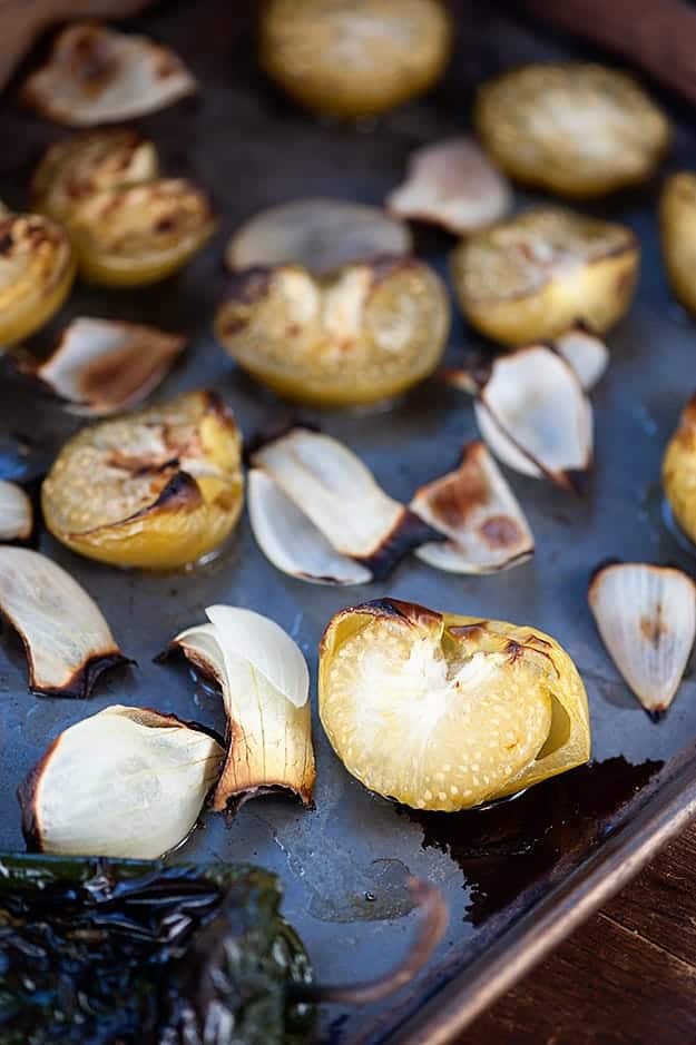 A baking sheet with pieces of onion on it.