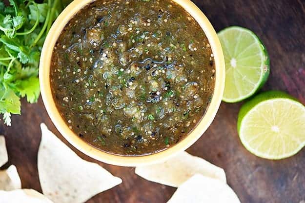 Overhead view of salsa verde on a wooden table.