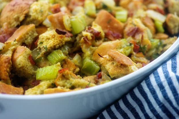 white baking dish full of stuffing for Thanksgiving.