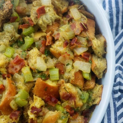 classic stuffing recipe with bacon in white baking dish.