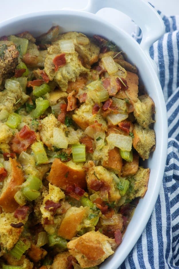 classic stuffing recipe with bacon in white baking dish.