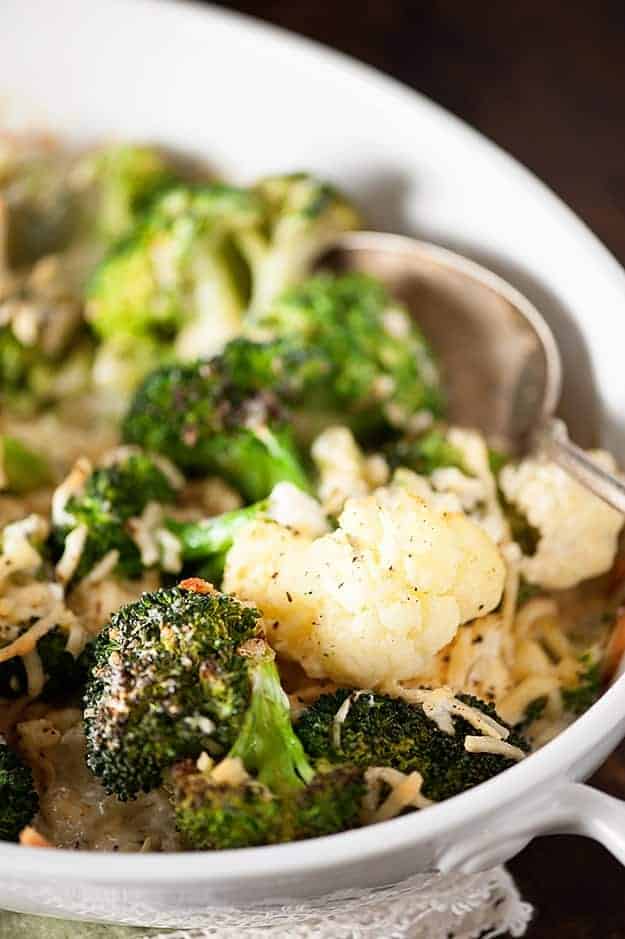 A close up of a white bowl of cauliflower and broccoli.